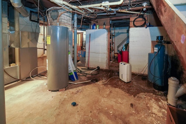 375 S Bridge St, Markesan, WI 53946 - unfinished below grade area with water heater, a water softener system, and heating unit