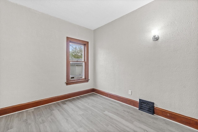 3046 N 57th St, Milwaukee, WI 53210 - empty room featuring wood finished floors, baseboards, and a textured wall