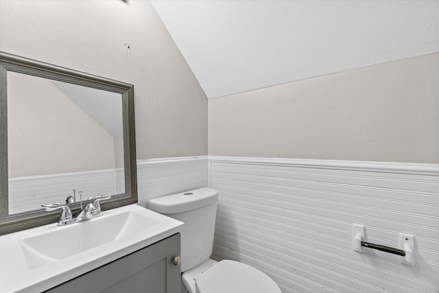3046 N 57th St, Milwaukee, WI 53210 - half bathroom with lofted ceiling, toilet, vanity, and wainscoting