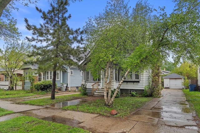 3046 N 57th St, Milwaukee, WI 53210 - view of front of property with concrete driveway, a garage, and an outdoor structure