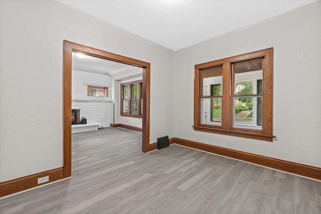 3046 N 57th St, Milwaukee, WI 53210 - spare room featuring wood finished floors, healthy amount of natural light, and baseboards