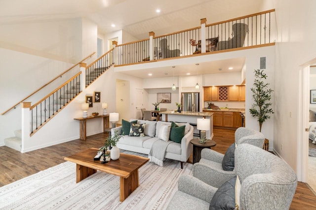 2725 Hidden Dr, Saint Francis, WI 53235 - living room featuring wood finished floors, a high ceiling, stairs, baseboards, and recessed lighting