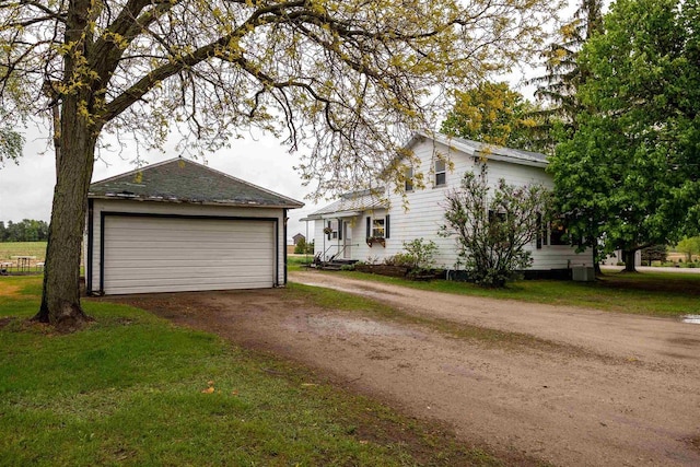 E3722 County Road Ee, Waupaca, WI 54981 - view of front of house with an outbuilding, a detached garage, and a front lawn