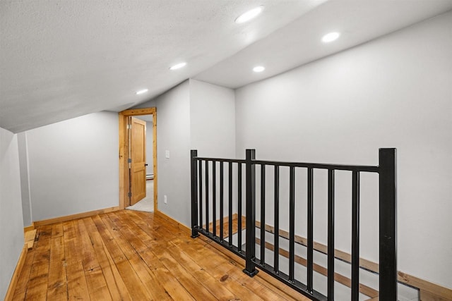 E3722 County Road Ee, Waupaca, WI 54981 - bonus room featuring recessed lighting, hardwood / wood-style floors, baseboards, and a textured ceiling