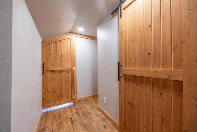 E3722 County Road Ee, Waupaca, WI 54981 - corridor featuring wood finished floors, vaulted ceiling, a barn door, baseboards, and recessed lighting