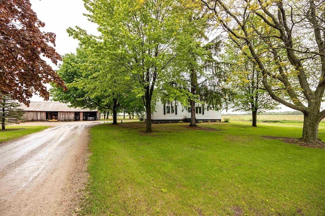 E3722 County Road Ee, Waupaca, WI 54981 - view of property hidden behind natural elements featuring driveway, a front lawn, and an outdoor structure