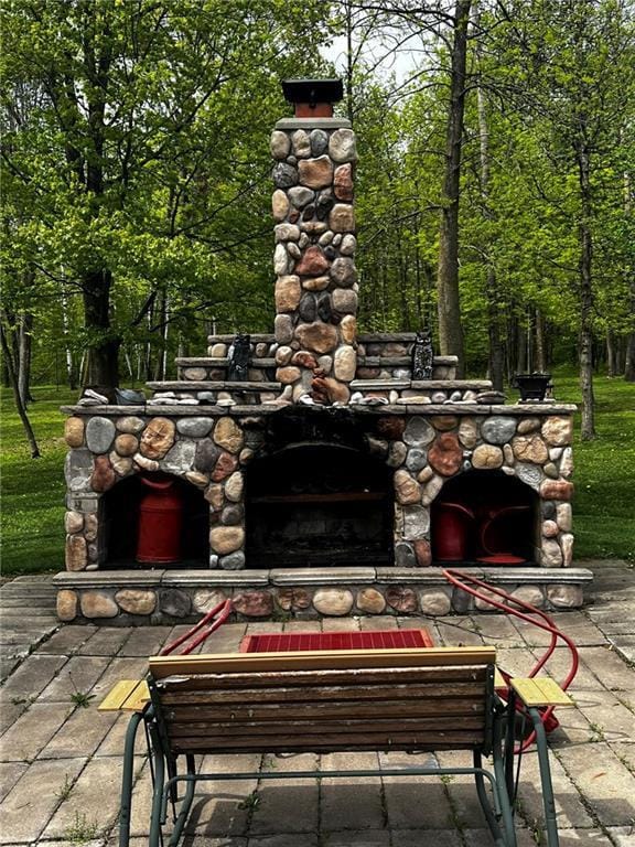 10384 W County Line Rd, Exeland, WI 54835 - view of patio featuring an outdoor stone fireplace