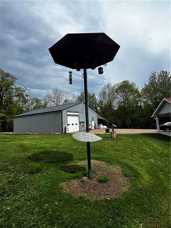10384 W County Line Rd, Exeland, WI 54835 - view of grassy yard with a detached garage, an outbuilding, and a pole building