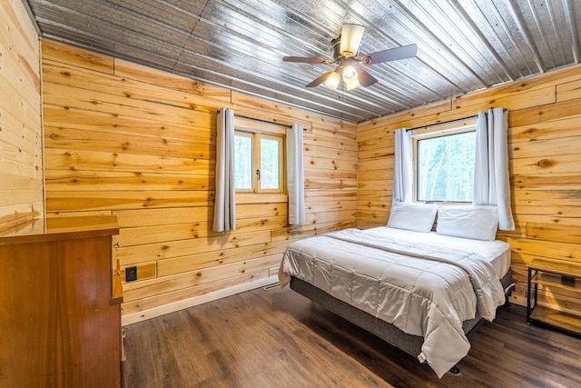 N11594 Woodland Dr, Tomahawk, WI 54487 - bedroom with multiple windows, dark wood-style flooring, wooden ceiling, wood walls, and a ceiling fan