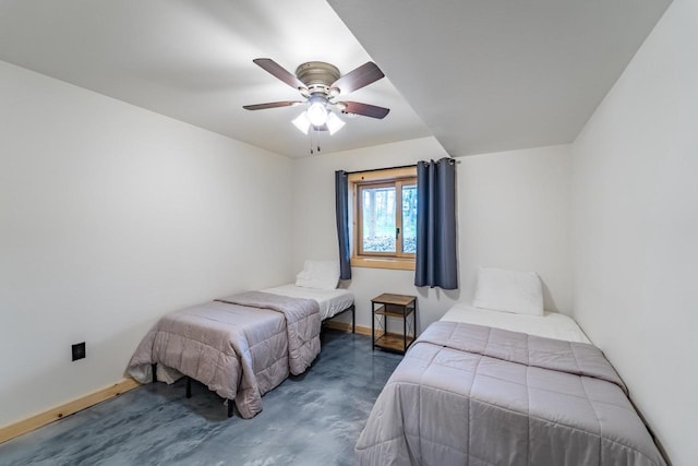 N11594 Woodland Dr, Tomahawk, WI 54487 - bedroom with baseboards, concrete flooring, and a ceiling fan