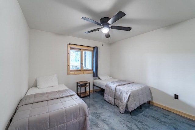 N11594 Woodland Dr, Tomahawk, WI 54487 - bedroom featuring baseboards, finished concrete floors, and ceiling fan