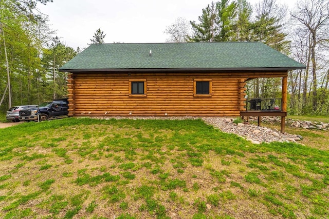 N11594 Woodland Dr, Tomahawk, WI 54487 - rear view of property with log exterior, a yard, and roof with shingles