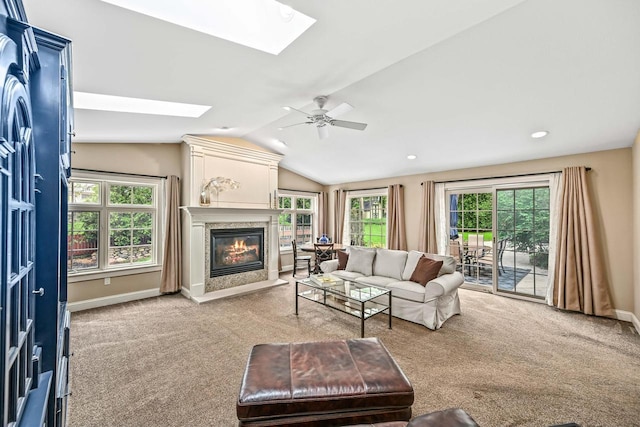 1333 N 120th St, Wauwatosa, WI 53226 - carpeted living room featuring a skylight, a fireplace with flush hearth, vaulted ceiling, plenty of natural light, and a ceiling fan