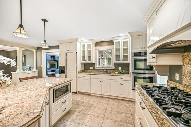 1333 N 120th St, Wauwatosa, WI 53226 - kitchen with stainless steel appliances, a sink, custom exhaust hood, glass insert cabinets, and pendant lighting