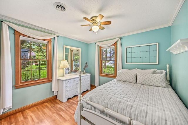 1333 N 120th St, Wauwatosa, WI 53226 - bedroom with multiple windows, ornamental molding, wood finished floors, baseboards, and ceiling fan
