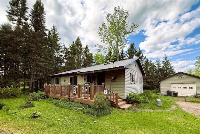 10302W Cty Rd, D, Exeland, WI 54835 - view of front of home with a garage, an outbuilding, a front yard, and a deck