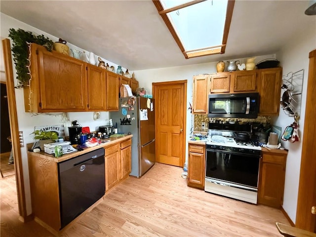 10302W Cty Rd, D, Exeland, WI 54835 - kitchen featuring appliances with stainless steel finishes, light wood-style floors, light countertops, and a skylight