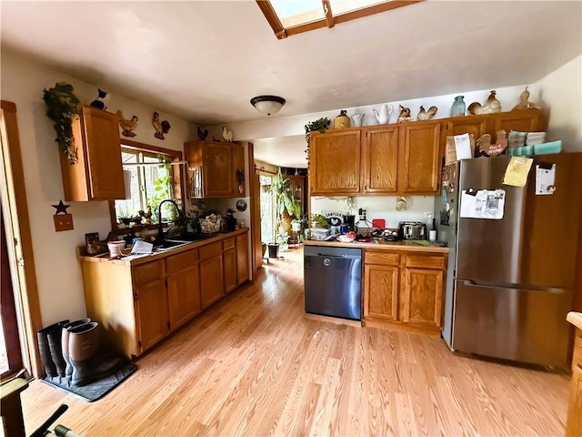 10302W Cty Rd, D, Exeland, WI 54835 - kitchen featuring freestanding refrigerator, dishwasher, a sink, light wood finished floors, and brown cabinets