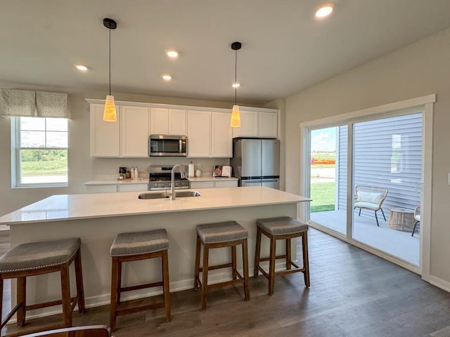 505 Oak Opening Dr, Stoughton, WI 53589 - kitchen featuring appliances with stainless steel finishes, a sink, an island with sink, white cabinets, and light countertops