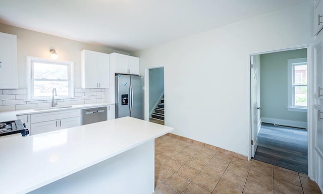 3834 Sheridan Rd, Kenosha, WI 53140 - kitchen featuring stainless steel appliances, a sink, plenty of natural light, and backsplash