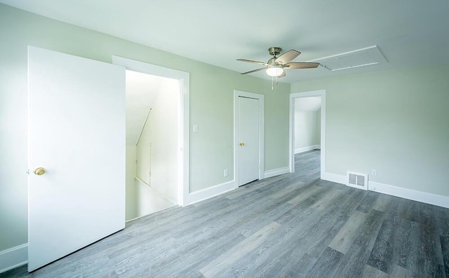 3834 Sheridan Rd, Kenosha, WI 53140 - unfurnished bedroom with attic access, wood finished floors, baseboards, and ceiling fan