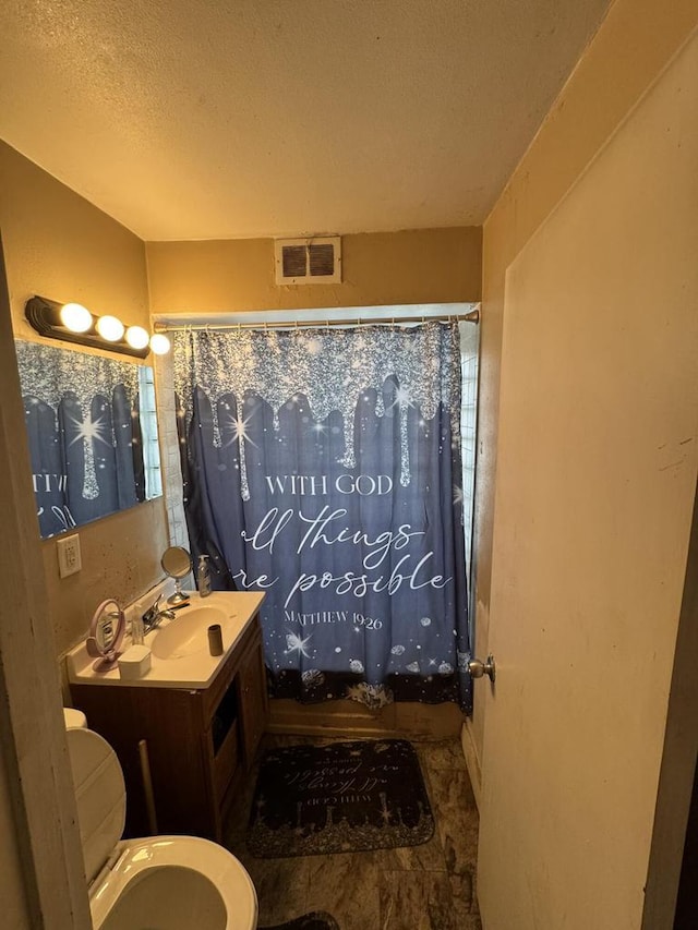 7248 W Potomac Ave, Milwaukee, WI 53216 - bathroom featuring toilet, vanity, and a textured ceiling
