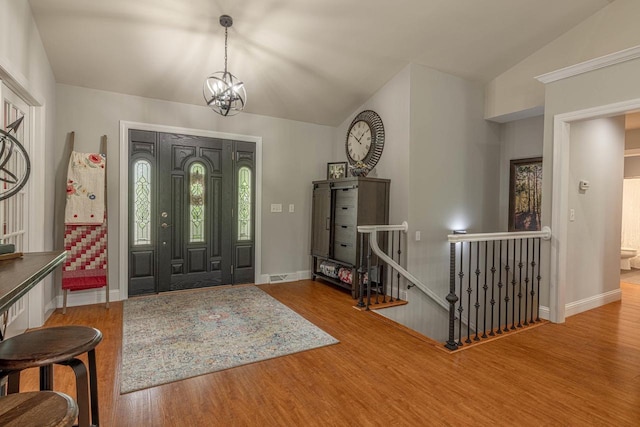 220 Grove St, Ridgeway, WI 53582 - entrance foyer with wood finished floors, lofted ceiling, baseboards, and a chandelier