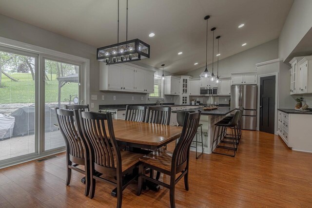 220 Grove St, Ridgeway, WI 53582 - dining area featuring wood finished floors, vaulted ceiling, and recessed lighting