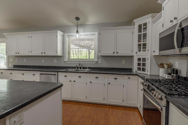 220 Grove St, Ridgeway, WI 53582 - kitchen featuring a sink, stainless steel appliances, dark countertops, and plenty of natural light