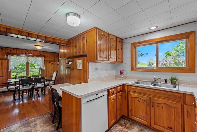 2901 W Forest Hill Ave, Franklin, WI 53132 - kitchen with white dishwasher, a sink, brown cabinetry, a peninsula, and light countertops