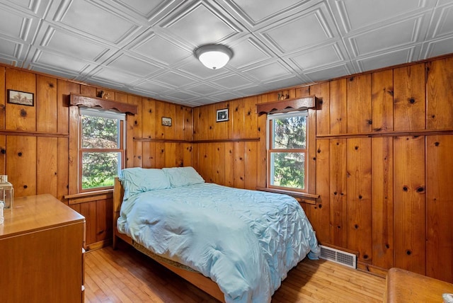 2901 W Forest Hill Ave, Franklin, WI 53132 - bedroom featuring an ornate ceiling, light wood-type flooring, and wood walls