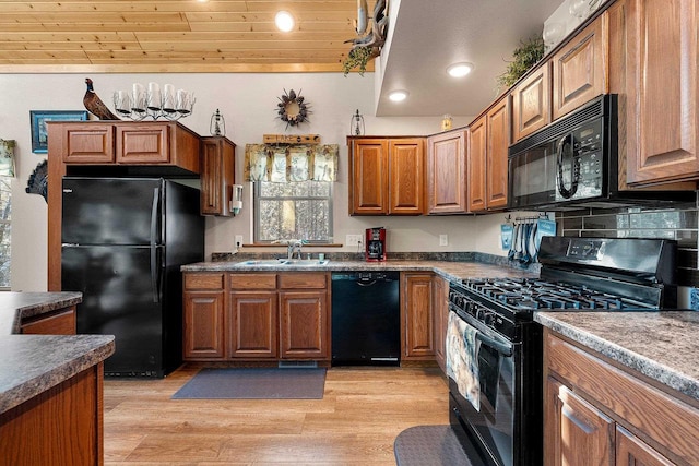 W6554 Wolf Lake Rd, Wausaukee, WI 54177 - kitchen featuring black appliances, a sink, brown cabinetry, light wood-type flooring, and recessed lighting