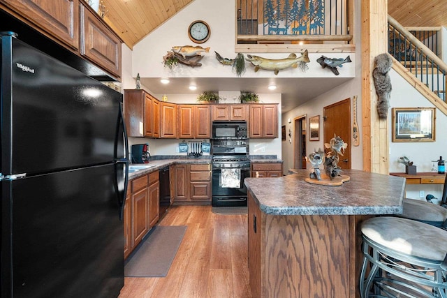 W6554 Wolf Lake Rd, Wausaukee, WI 54177 - kitchen featuring black appliances, high vaulted ceiling, dark countertops, light wood-style floors, and wooden ceiling