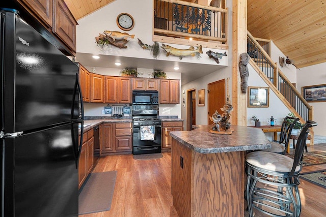 W6554 Wolf Lake Rd, Wausaukee, WI 54177 - kitchen with black appliances, high vaulted ceiling, wooden ceiling, brown cabinets, and dark countertops