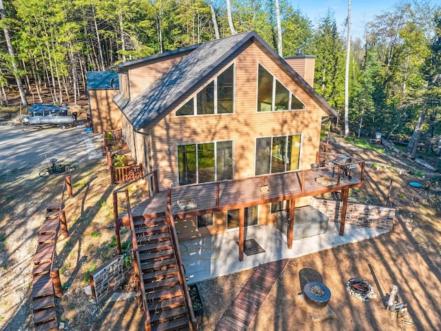 W6554 Wolf Lake Rd, Wausaukee, WI 54177 - view of front of house with stairs, a deck, and a chimney