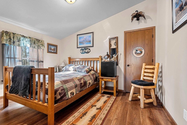 W6554 Wolf Lake Rd, Wausaukee, WI 54177 - bedroom with lofted ceiling, wood finished floors, and baseboards