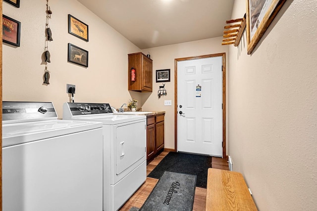 W6554 Wolf Lake Rd, Wausaukee, WI 54177 - laundry area with light wood finished floors, separate washer and dryer, and cabinet space
