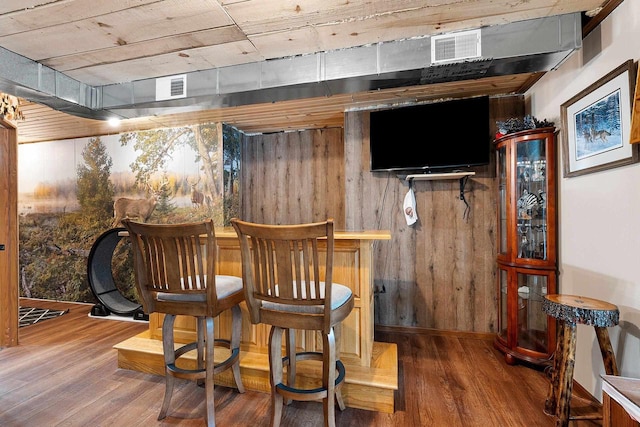 W6554 Wolf Lake Rd, Wausaukee, WI 54177 - indoor dry bar featuring wood finished floors, wooden walls, and baseboards
