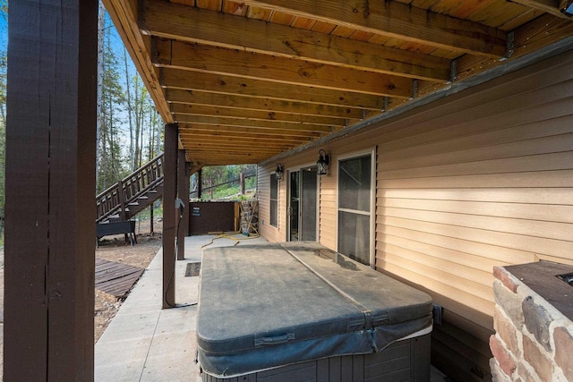 W6554 Wolf Lake Rd, Wausaukee, WI 54177 - view of patio featuring a hot tub and stairway