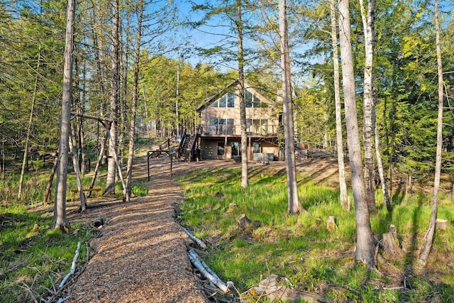 W6554 Wolf Lake Rd, Wausaukee, WI 54177 - back of house featuring a wooden deck, stairs, and a forest view