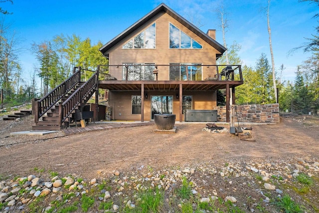 W6554 Wolf Lake Rd, Wausaukee, WI 54177 - back of house with a deck, a chimney, stairs, and a hot tub