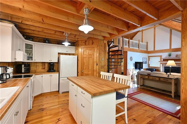 2706 28 1/8 St, Birchwood, WI 54817 - kitchen featuring white appliances, tile counters, a breakfast bar area, white cabinets, and glass insert cabinets