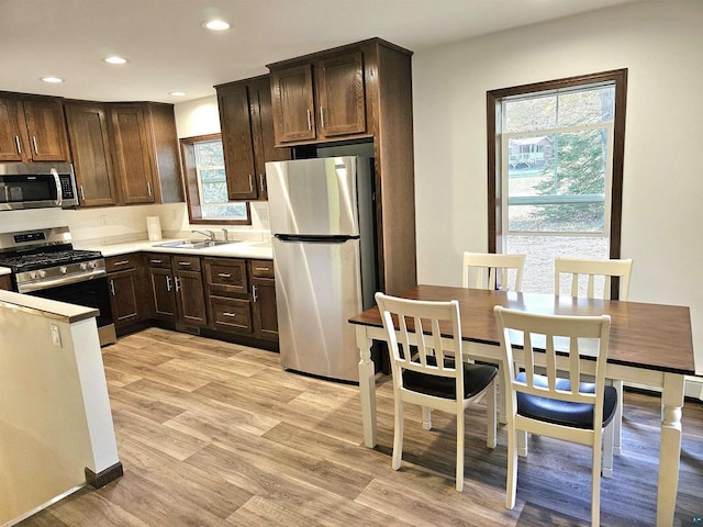 37375 E Bresette Hill Rd, Bayfield, WI 54814 - kitchen with appliances with stainless steel finishes, a sink, healthy amount of natural light, dark brown cabinetry, and recessed lighting