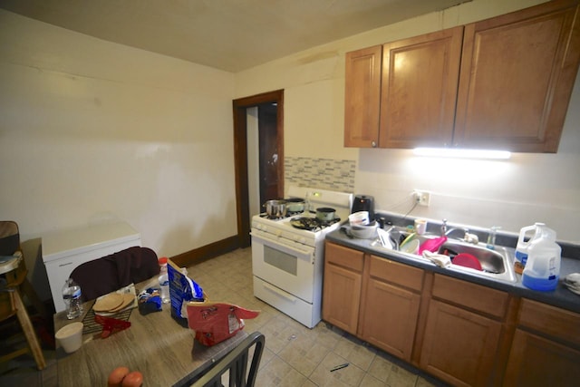 2435 N 44th St Unit 2437, Milwaukee, WI 53210 - kitchen with white gas range, tasteful backsplash, and brown cabinets