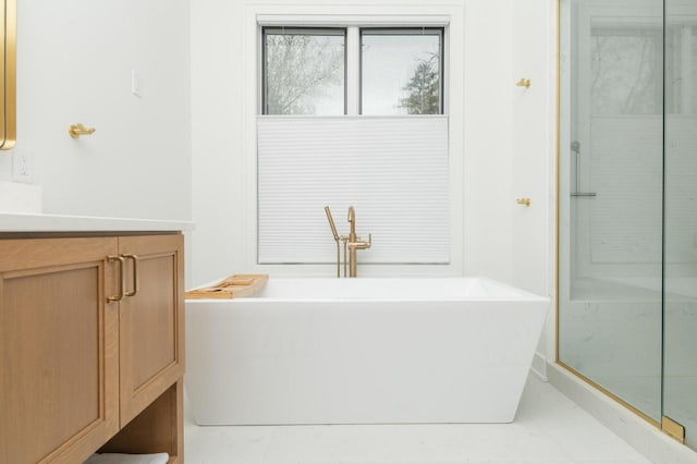 W329N6597 Forest Dr, Hartland, WI 53029 - bathroom featuring a soaking tub, vanity, and a shower with door