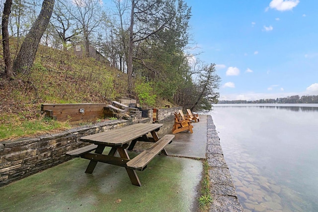 W329N6597 Forest Dr, Hartland, WI 53029 - dock area featuring a water view, outdoor dining space, and a patio
