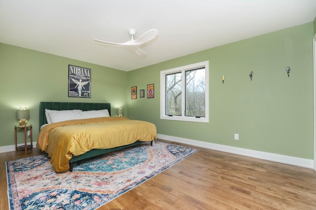 W329N6597 Forest Dr, Hartland, WI 53029 - bedroom featuring wood finished floors, baseboards, and ceiling fan