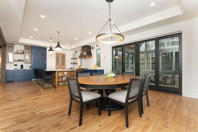 W329N6597 Forest Dr, Hartland, WI 53029 - dining area featuring a raised ceiling, light wood-style floors, and recessed lighting