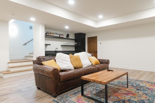 W329N6597 Forest Dr, Hartland, WI 53029 - living room with bar with sink, light wood-type flooring, stairway, recessed lighting, and baseboards