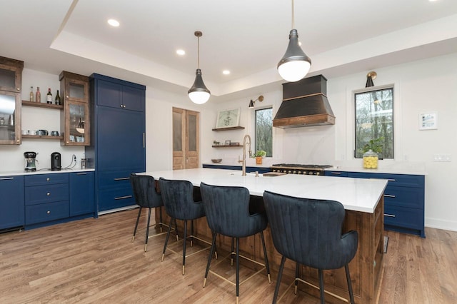 W329N6597 Forest Dr, Hartland, WI 53029 - kitchen featuring custom exhaust hood, open shelves, blue cabinetry, light countertops, and recessed lighting